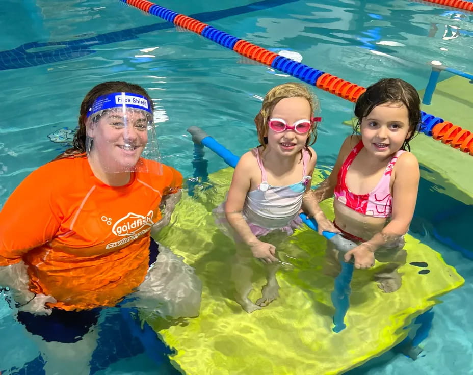 a man and two children in a pool