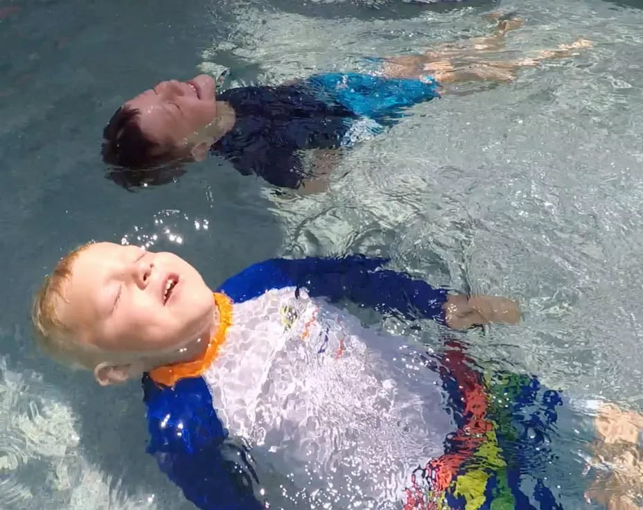 a boy swimming in water