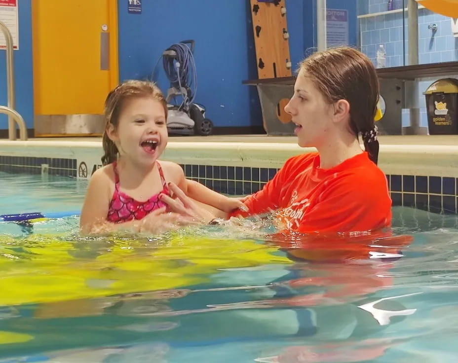 a couple of girls in a pool