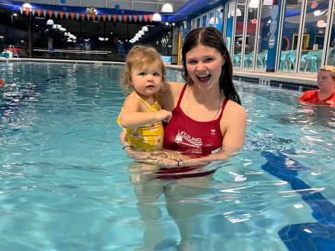 a person and a child in a pool