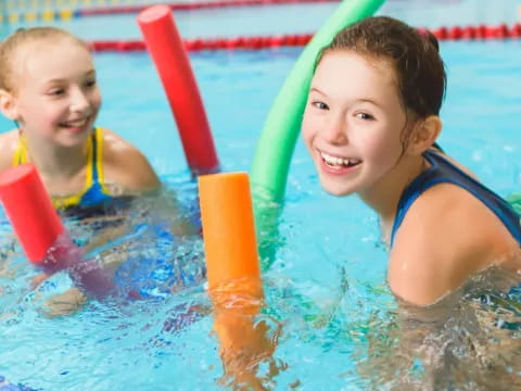 a couple of kids in a pool