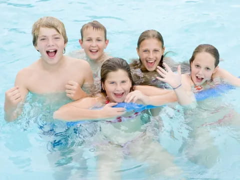a group of kids in a pool