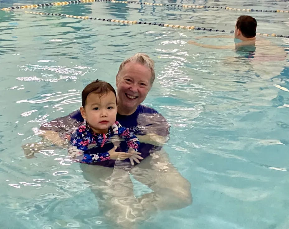a person and a child in a pool