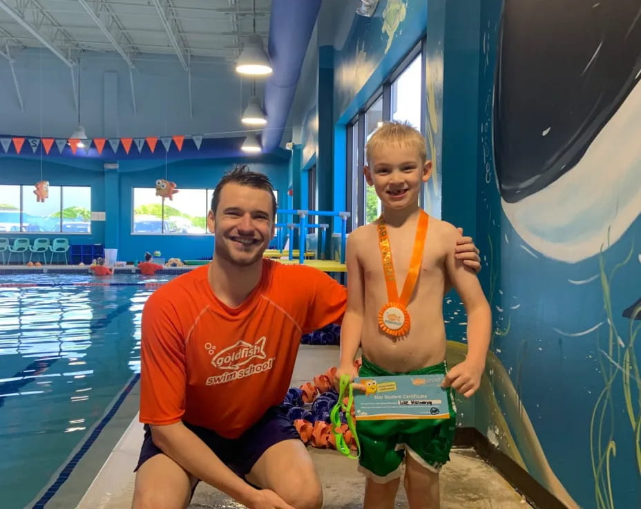 a person and a boy in a pool
