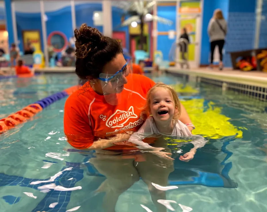 a person and a girl in a pool