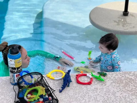 a baby playing in a pool