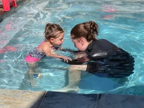 a person and a child in a pool