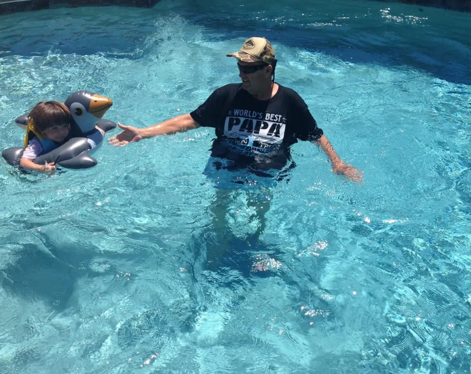 a man and a child in a pool