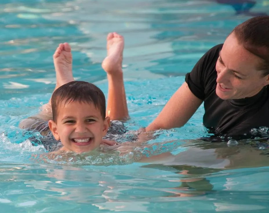 a man and a child in a pool