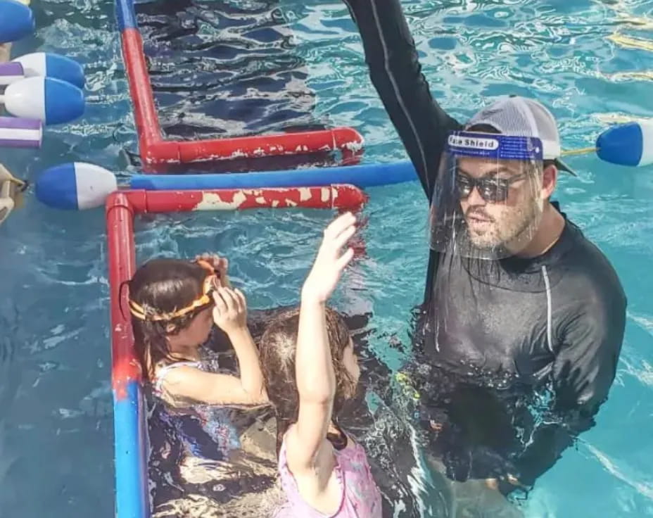 a person and a child in a pool