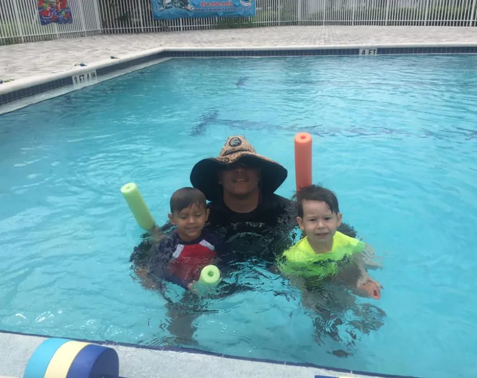 a person and two children in a pool