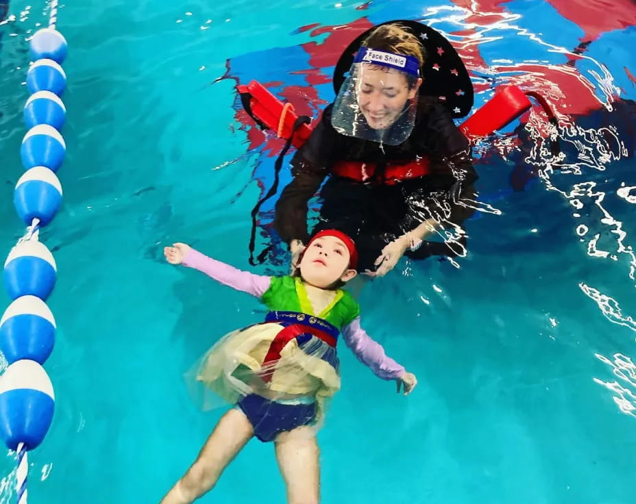 a person and a child in a pool