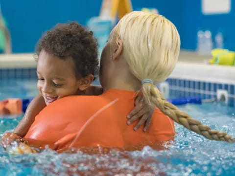 a boy and girl in a pool