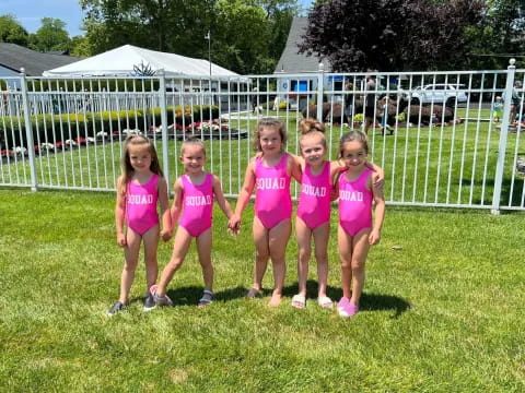 a group of girls in pink shirts