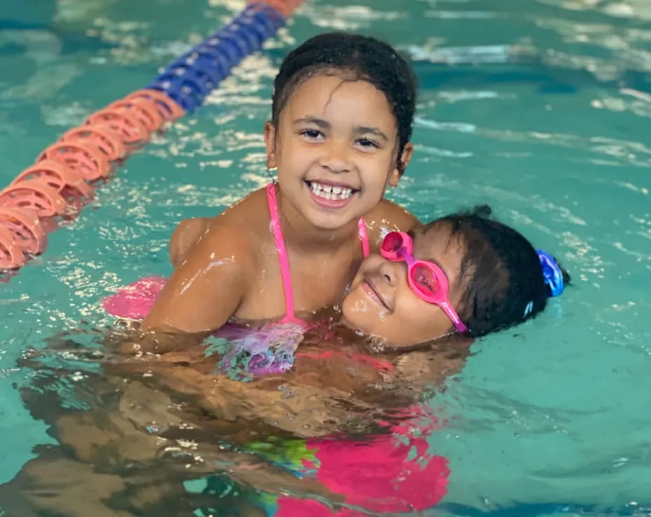 a person and a child in a pool