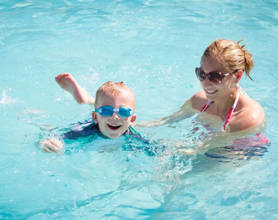 a person and a baby in a pool