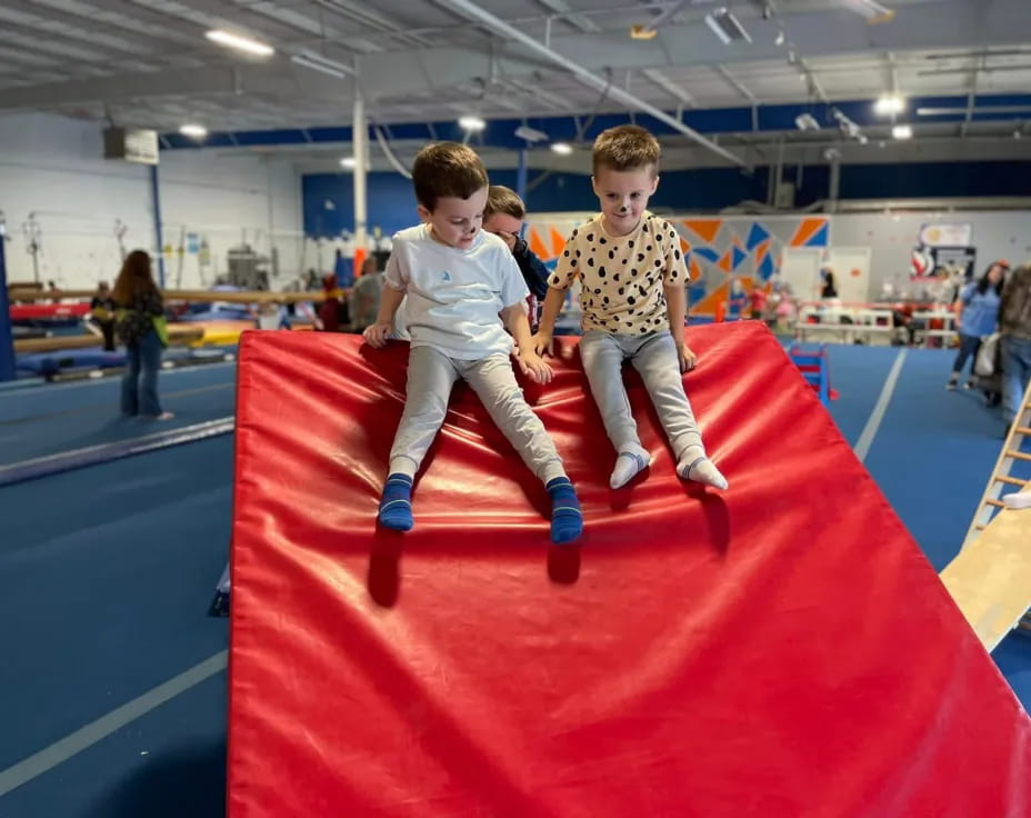 two boys on a red mat