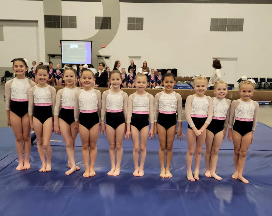 a group of women in white shirts