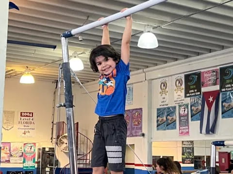 a boy holding a barbell