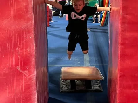 a child jumping on a slide