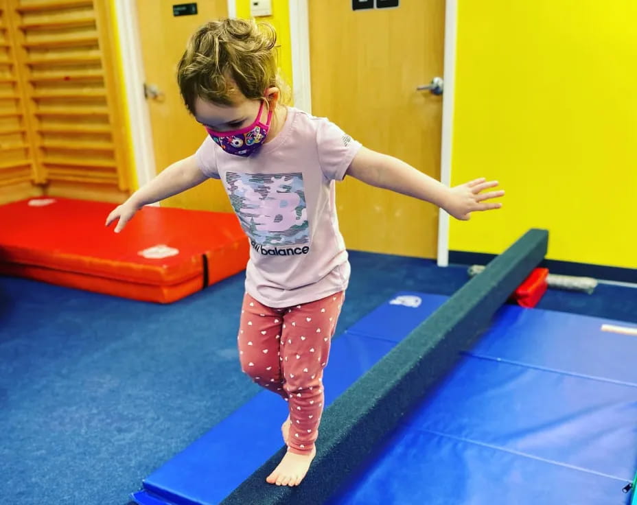 a child standing on a mat