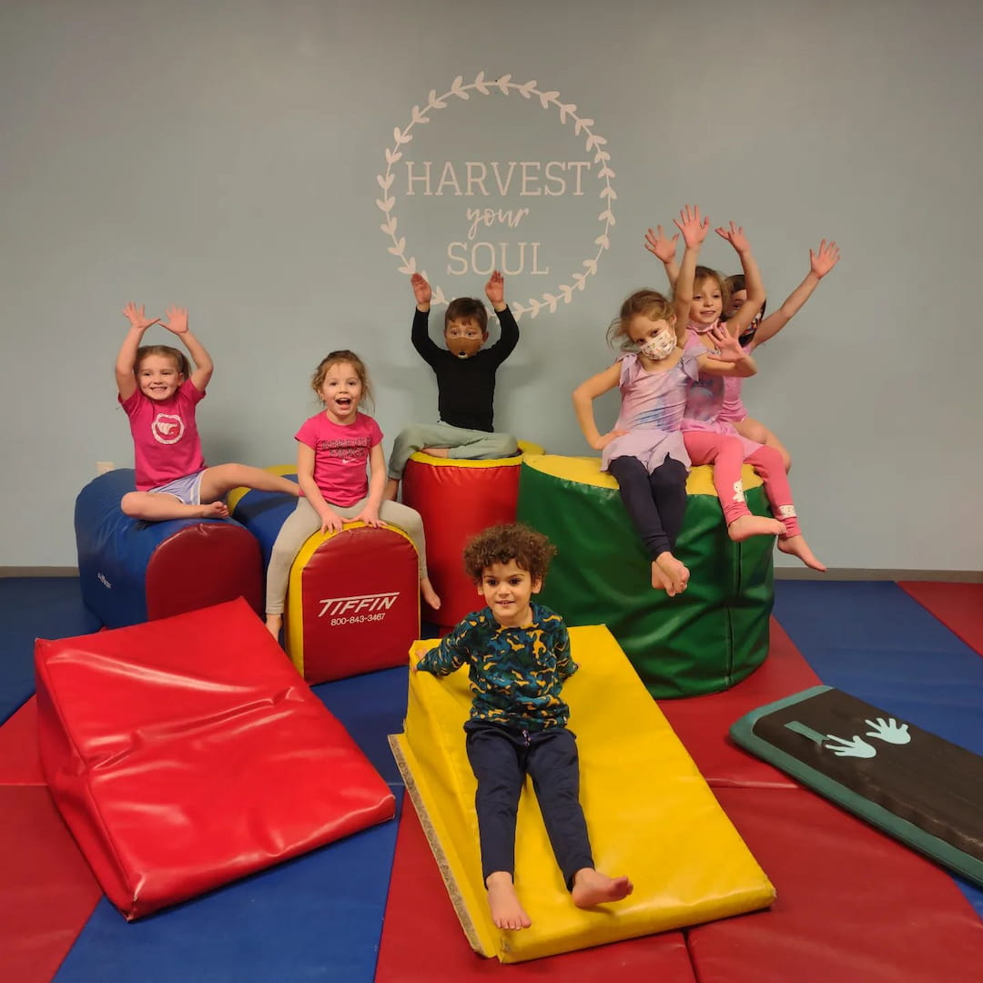 a group of kids sitting on colorful chairs