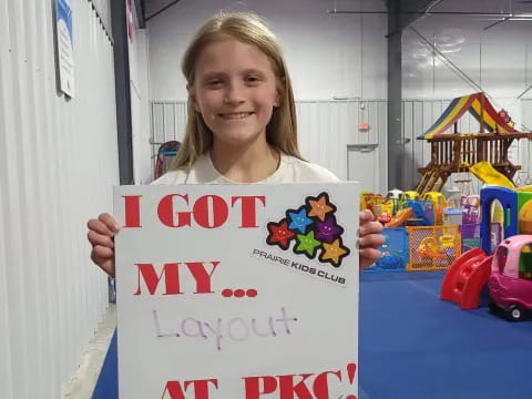 a girl holding a sign