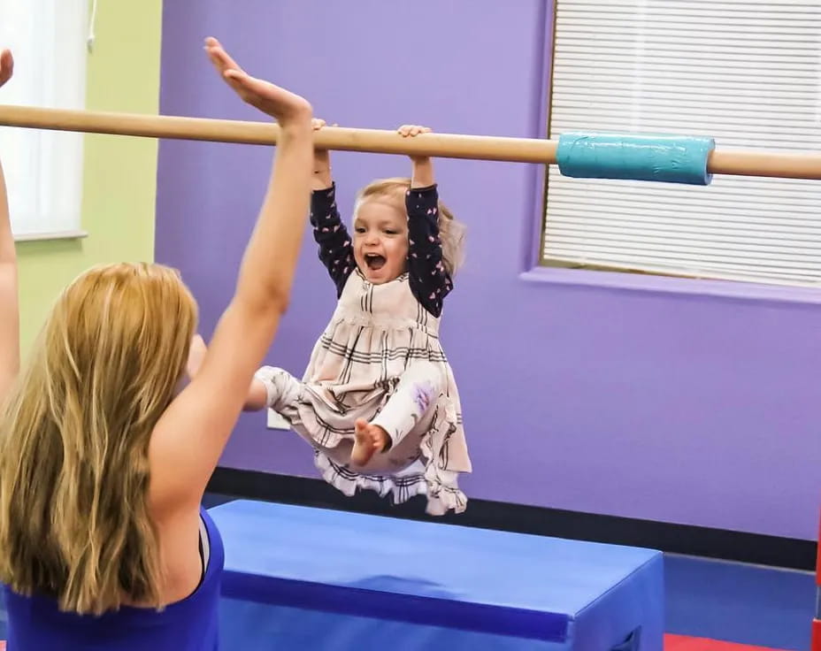 a girl with her arms raised