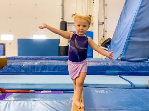 a girl jumping on a trampoline