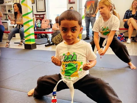 a young boy sitting on the floor