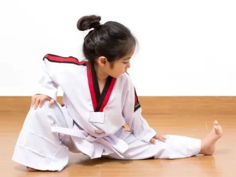 a young girl in a karate uniform