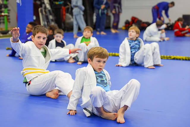 a group of children sitting on the ground