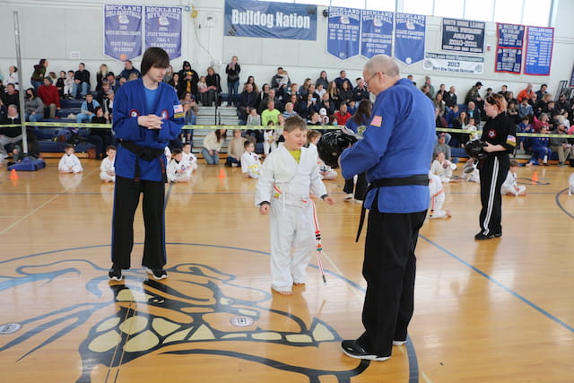 a person and a boy in a gym