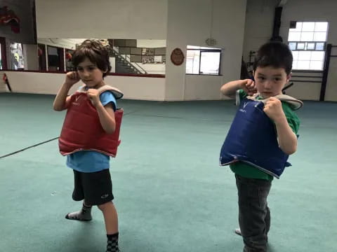 two boys holding blue balls