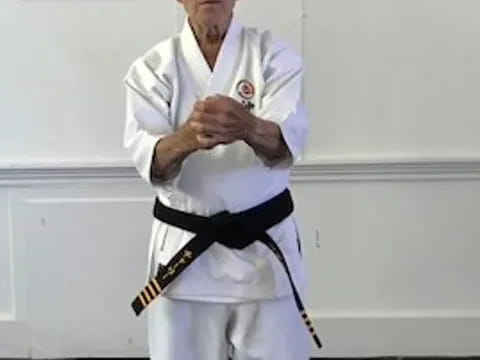 a man wearing a karate uniform