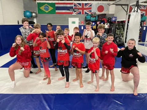 a group of children in red shirts