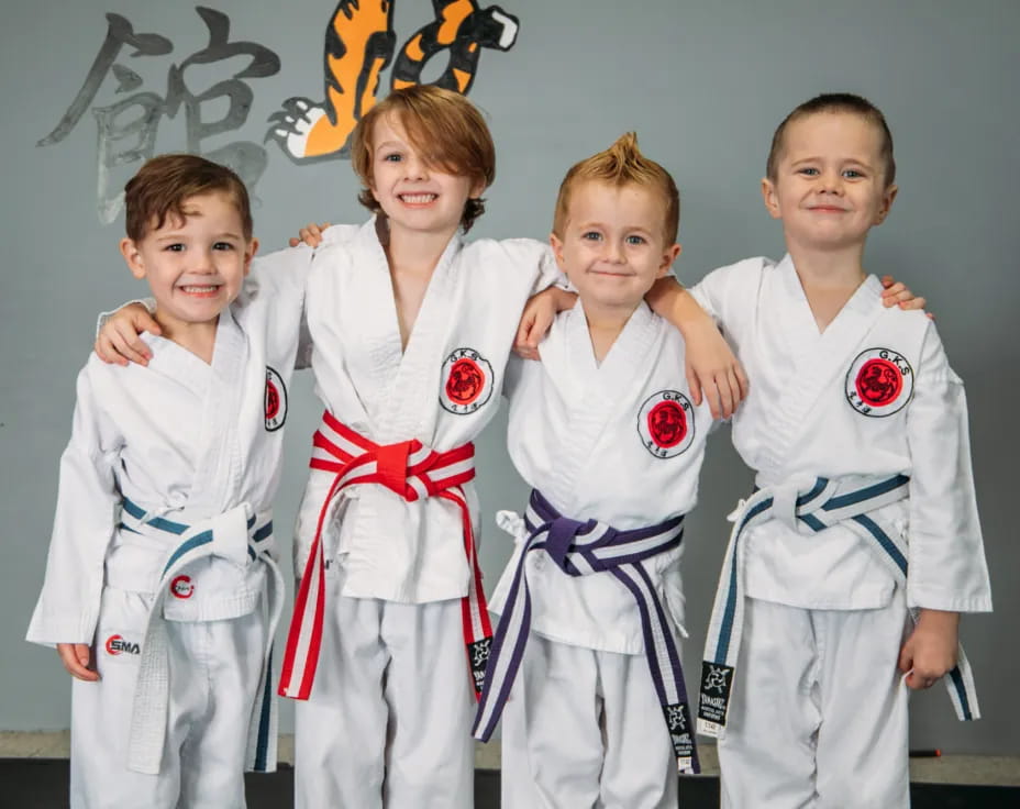 a group of kids in karate uniforms