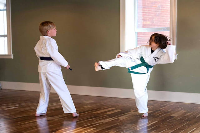 a boy and girl in karate uniforms