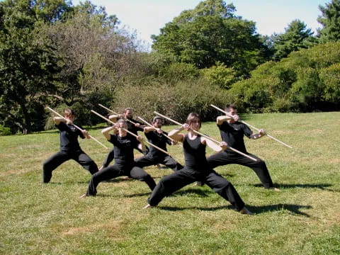 a group of people holding swords