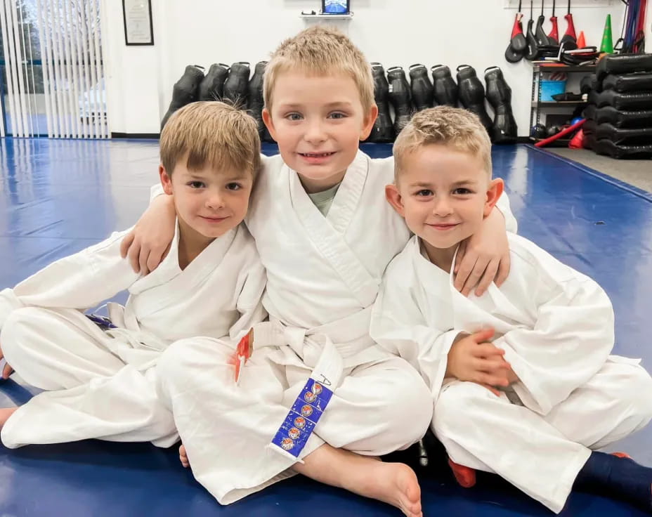 a group of boys in karate uniforms