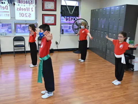a group of kids playing tennis