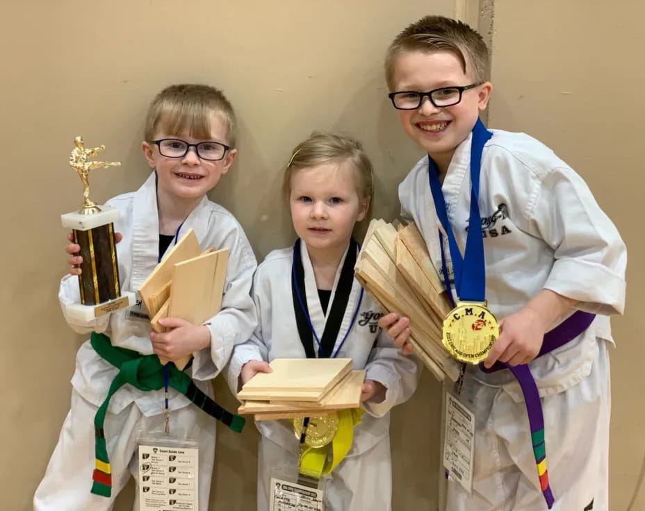 a group of people holding trophies