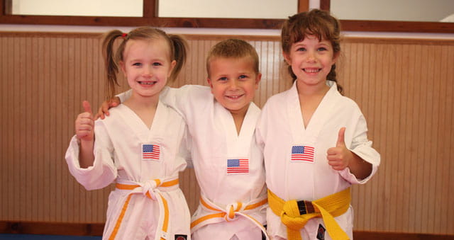 a group of children in white shirts