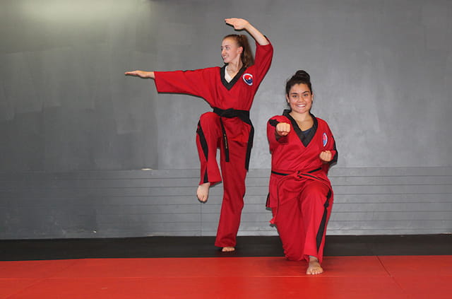 two women in red martial arts uniforms