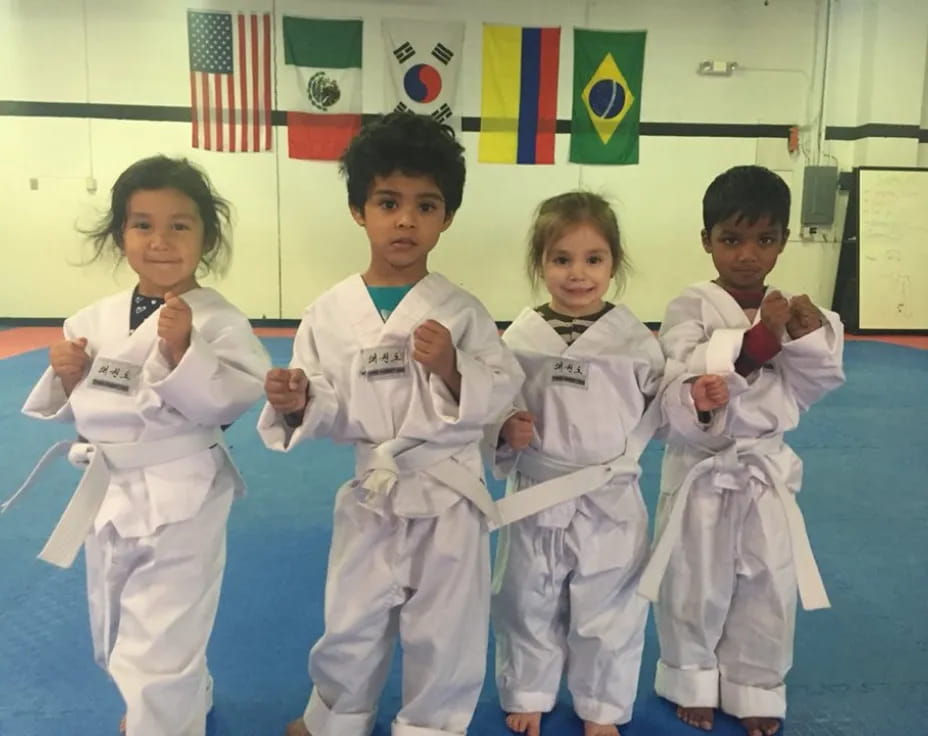 a group of kids in karate uniforms