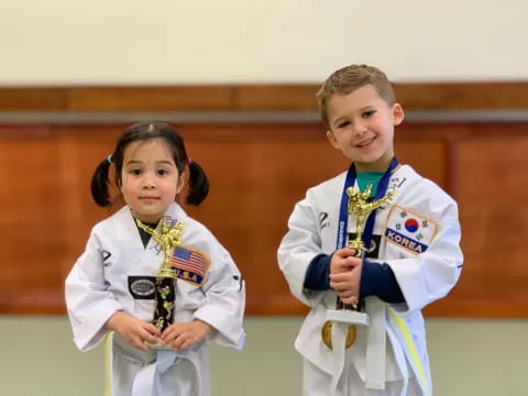 a few children in karate uniforms