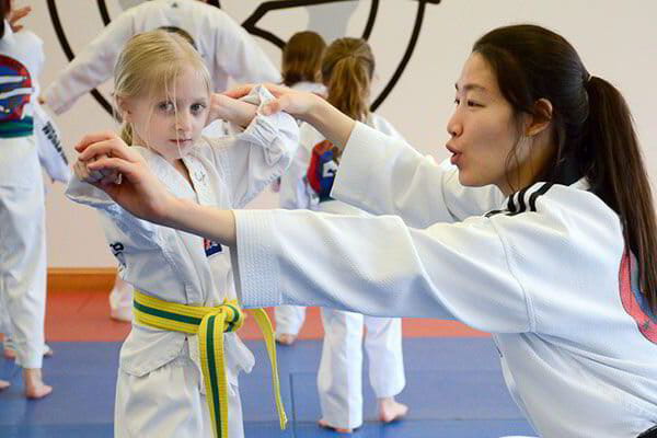 a group of girls in karate uniforms