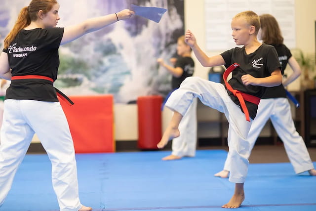 a group of people in a martial arts class