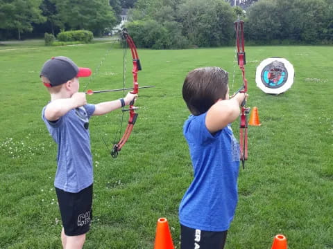 a couple of boys shooting bows