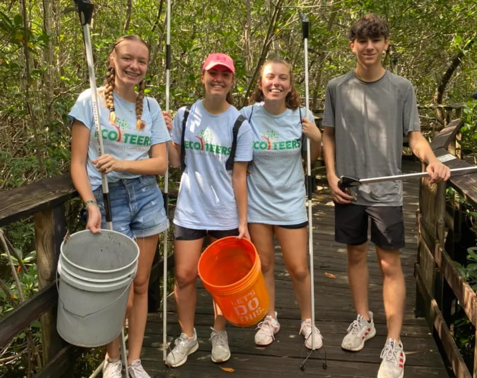 a group of people holding buckets